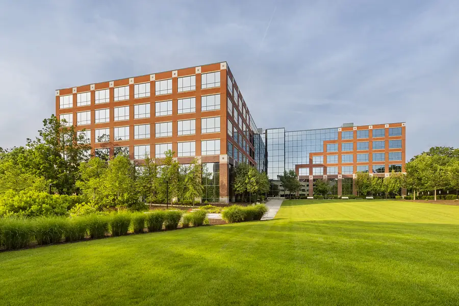 Office building framed by beautiful landscaping and a neatly maintained lawn